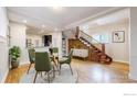 Dining room and staircase with wood floors and trim throughout the main floor at 3931 Osage St, Denver, CO 80211