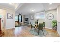 Bright and open living room flowing from dining area with hardwood floors and lots of light at 3931 Osage St, Denver, CO 80211