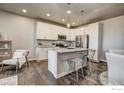 Bright kitchen showcases white cabinetry, stainless steel appliances, and pendant lighting above the island at 410 High Point Dr # 102, Longmont, CO 80504
