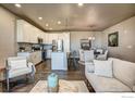 Inviting open-concept living area with modern kitchen, dining, and living spaces at 410 High Point Dr # 102, Longmont, CO 80504