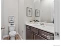 Well-lit bathroom with a vanity, framed art, and modern fixtures for a clean, updated look at 420 High Point Dr # 102, Longmont, CO 80504