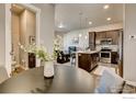 Open concept kitchen featuring stainless steel appliances, a center island, and stylish finishes at 420 High Point Dr # 102, Longmont, CO 80504
