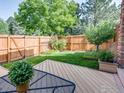 Enjoy the backyard with a wood deck and lawn surrounded by mature trees at 4800 Osage Dr # 12B, Boulder, CO 80303