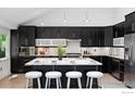 Close up of an island with sleek cabinetry, marble countertops, and modern appliances at 530 W Hackberry St, Louisville, CO 80027