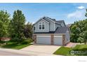Charming two-story home with a spacious three-car garage, manicured lawn, and mature trees at 5603 Pierson Mountain Ave, Longmont, CO 80503