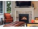 Cozy living room featuring a fireplace, comfortable seating, and natural light at 5695 Aurora Pl, Boulder, CO 80303