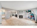 Spacious living room featuring a cozy fireplace and neutral carpeting at 6710 W 84Th Way # 19, Arvada, CO 80003