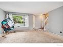 Inviting living room showcasing a large window and neutral carpet at 6710 W 84Th Way # 19, Arvada, CO 80003