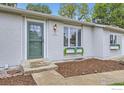 Inviting front entrance with flower boxes, updated paint, and a concrete walkway to the home's front door at 7442 Jay Ct, Arvada, CO 80003