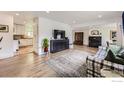 Open concept living room featuring hardwood floors, fireplace, and seamless flow to adjacent rooms, ideal for entertaining at 7442 Jay Ct, Arvada, CO 80003