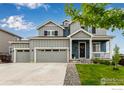 Charming two-story home featuring a covered porch, manicured lawn and three car garage at 10 N Quantock St, Aurora, CO 80018