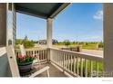 Inviting front porch with chairs, creating a relaxing and welcoming outdoor space at 10 N Quantock St, Aurora, CO 80018