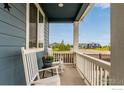 Inviting front porch with chairs, creating a relaxing and welcoming outdoor space at 10 N Quantock St, Aurora, CO 80018