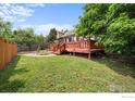 Spacious backyard features a wooden deck, lush lawn, and mature trees, perfect for outdoor gatherings at 1020 10Th St, Boulder, CO 80302