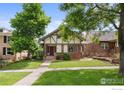 Beautiful home with a well-manicured lawn and mature trees, showcasing its classic architectural style at 1020 10Th St, Boulder, CO 80302