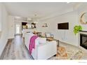 Bright living room with open floor plan into kitchen and wood-look floors at 1240 Wren Ct # D, Longmont, CO 80501