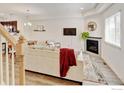 Bright living room with fireplace, modern furnishings, and wood-look floors at 1240 Wren Ct # D, Longmont, CO 80501