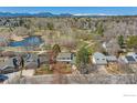 Property shown in aerial view surrounded by mature trees and lush landscaping at 1449 Adams Pl, Louisville, CO 80027