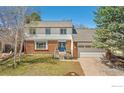 Attractive two-story home boasts a brick facade and well-maintained lawn at 1449 Adams Pl, Louisville, CO 80027