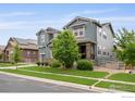 Charming two-story home with stone accents and well-kept landscaping on a sunny day at 15998 Humboldt Peak Dr, Broomfield, CO 80023