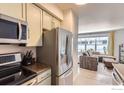 Kitchen featuring stainless appliances, granite countertops, and a view into the adjacent living area at 1623 Saint Paul St # 310, Denver, CO 80206