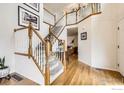 Bright foyer with hardwood floors and staircase leading to the second level at 1641 Cedarwood Dr, Longmont, CO 80504