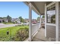 Inviting view from covered porch, showcasing neighborhood street and well-maintained landscaping at 1641 Cedarwood Dr, Longmont, CO 80504