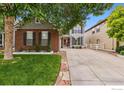 Beautiful home exterior featuring a spacious driveway, well-kept lawn, and classic architectural details at 1706 Naples Ln, Longmont, CO 80503
