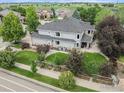 Aerial view of a well maintained single Gathering home with mature trees and large manicured lawn at 1766 Montgomery Cir, Longmont, CO 80504