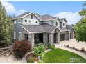 Well maintained two-story home featuring manicured landscaping and a charming covered front porch at 1766 Montgomery Cir, Longmont, CO 80504