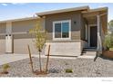 Inviting home featuring neutral exterior, landscaped yard, and modern architectural details at 1790 Mount Meeker Ave, Berthoud, CO 80513
