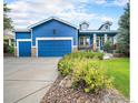 Beautiful blue home with well-maintained landscaping, stone accents, and a spacious three-car garage at 1874 Ute Creek Dr, Longmont, CO 80504