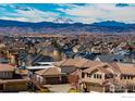 A view of the neighborhood with snow-capped mountains in the distance on a sunny day at 2005 Calico Ct, Longmont, CO 80503