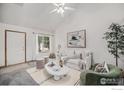 Bright living room with a vaulted ceiling, neutral furniture, and a large window offering natural light at 2108 Meadow Ct, Longmont, CO 80501