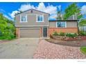Beautiful two-story home with a two-car garage and a brick and stone front at 2113 Spencer St, Longmont, CO 80501