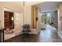 Inviting foyer with sleek tile flooring, a decorative column, and an open view of the living area with scenic windows at 23 Hess Ave, Golden, CO 80401
