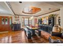 Stylish dining room with hardwood floors, a rustic table setting, and a beautiful bay window at 233 Elizabeth Ct, Fort Lupton, CO 80621