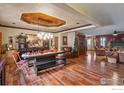 Elegant dining area featuring hardwood floors, a custom ceiling, and unique rustic decor at 233 Elizabeth Ct, Fort Lupton, CO 80621