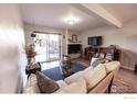 Comfortable living room featuring a fireplace and sliding glass doors to the backyard at 2636 Juniper Ave # 39-2, Boulder, CO 80304