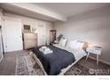 Cozy bedroom with a large bed, soft carpet, and a dresser with storage space at 2636 Juniper Ave # 39-2, Boulder, CO 80304