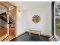 Sun-filled entryway features dark wood floors, bright walls, and an accent bench at 3260 Lafayette Dr, Boulder, CO 80305