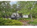 Charming home featuring a multi-level deck, mature trees, and professionally landscaped yard at 3260 Lafayette Dr, Boulder, CO 80305