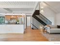 Open-concept living area featuring vaulted ceilings, wood floors and an open kitchen at 3260 Lafayette Dr, Boulder, CO 80305