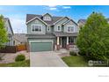 Charming two-story home boasts a well-maintained yard, two car garage, and inviting front porch at 3717 Desert Ridge Cir, Castle Rock, CO 80108