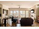 Bright living room with fireplace, large windows, hardwood floors, and comfortable seating at 4993 Clubhouse Ct, Boulder, CO 80301