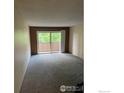 Cozy room featuring sliding glass doors and plush carpeting at 5102 Williams Fork Trl # 205, Boulder, CO 80301