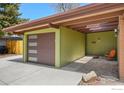 Lovely exterior featuring a garage and a serene courtyard sitting area for relaxation at 5450 Mohawk Rd, Littleton, CO 80123