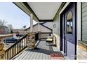 Inviting front porch featuring stone pillars, stylish seating, and a warm, welcoming entrance at 5895 E Conservation Dr, Frederick, CO 80504