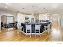 Bright, open kitchen featuring a large center island, modern appliances, and hardwood flooring at 5895 E Conservation Dr, Frederick, CO 80504