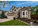 Charming two-story home with brick accents, bay windows, well-maintained landscaping, and attached garage at 6255 Collegiate Dr, Highlands Ranch, CO 80130